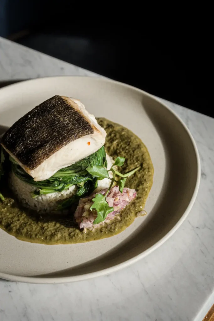 Charred butterfish, coconut rice, sautéed local greens, Thai green coconut sauce and sambal matah