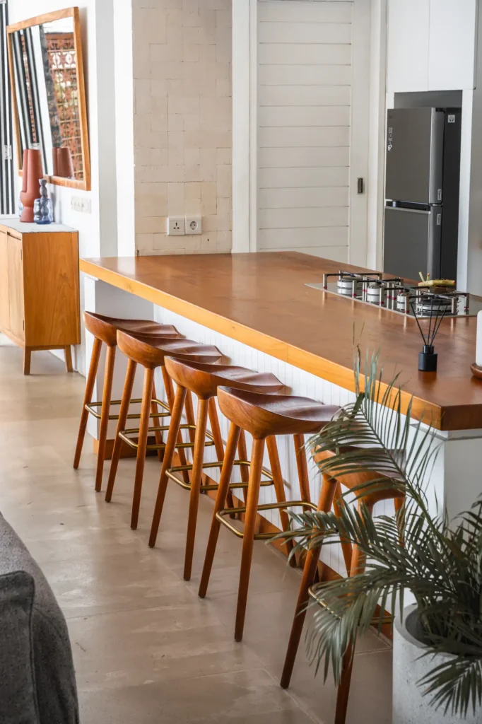 Kitchen island with teakwood bar stools and terracotta detailing at Lago Beach House Nusa Lembongan